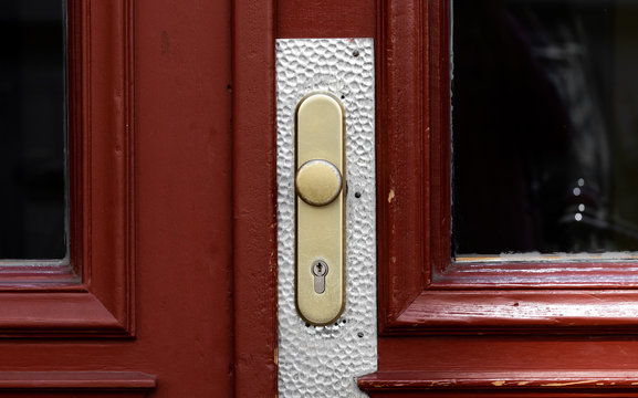 Door handle on a red wooden door