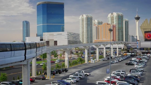 The Las Vegas Monorail passes by the Convention Center with hotels and casinos in the background.  	