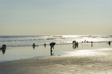 Crowd of people enjoy the sea breeze of Krambitan beach in Bali,Indonesia