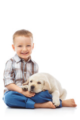 Boy with a labrador puppy, isolated on white