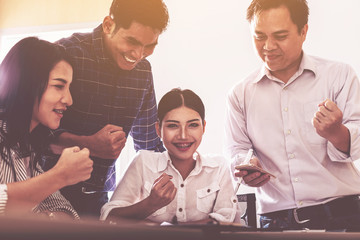 team of happy business people in smart casual wear looking at the Successful business; success and winning concept.