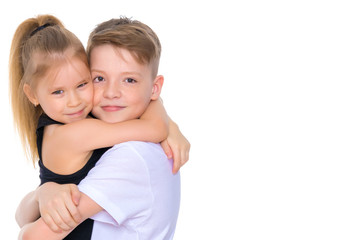 Brother and sister embrace.