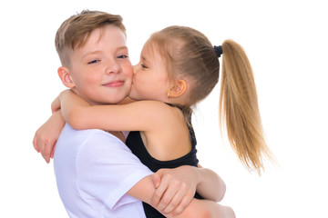 Brother and sister embrace.