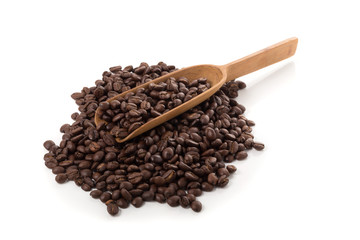 Roasted coffee beans in a wooden spoon isolated on a white background