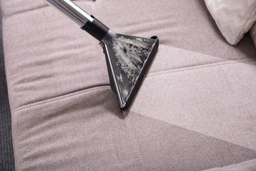 Close-up Of Vacuum Cleaner On Sofa