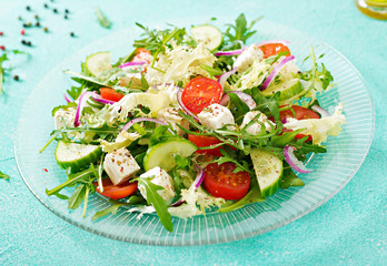 Salad of fresh vegetables - tomato, cucumber and feta cheese in Greek style