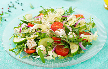 Salad of fresh vegetables - tomato, cucumber and feta cheese in Greek style