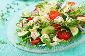 Salad of fresh vegetables - tomato, cucumber and feta cheese in Greek style