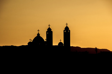 silhouette of the Coptic church on sunset background