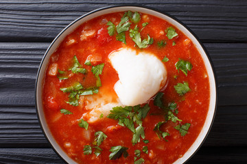 Delicious fish tomato stew with vegetables close-up in a bowl. Horizontal top view