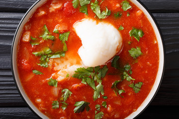 Sicilian fish tomato soup with vegetables close-up in a bowl. Horizontal top view