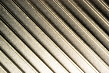 metallic silver background on which there are faces, light and shadow of metal
