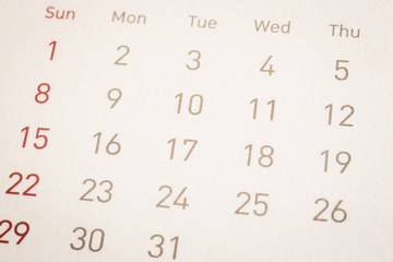 Obraz premium Closeup dates on calendar page, vintage style.