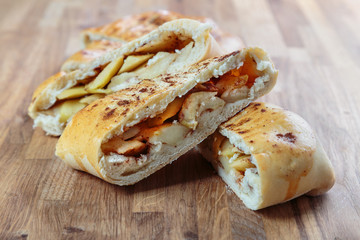 sliced pie with filling lies on the oak surface of the table