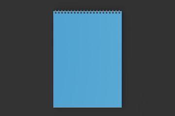 Blank blue notebook with metal spiral bound on black background