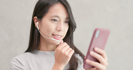 Woman talking on hand free with mobile phone