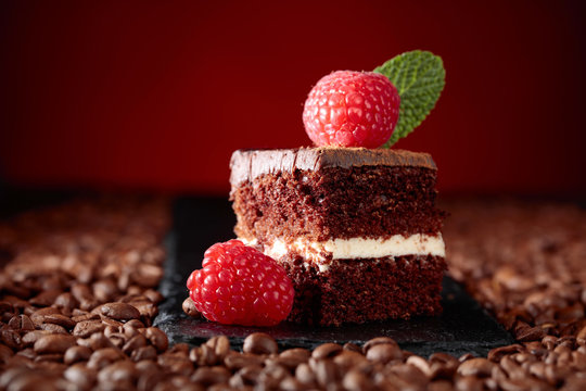 Closeup of chocolate cake with raspberry .