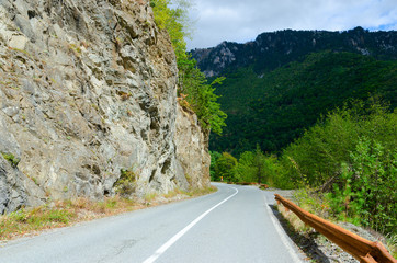 Mountain road in Montenegro, sharp turn at steep rock