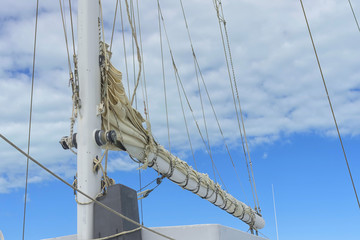 Fototapeta premium Fragment of the rigging of a sailing yacht against a blue sky wi