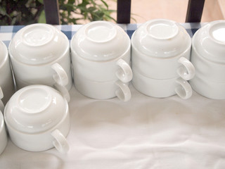 Many rows of white ceramic coffee cup