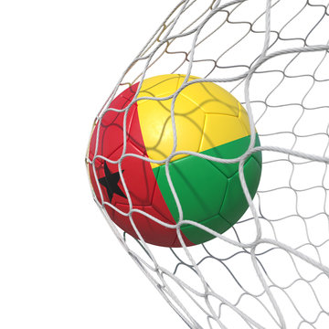 Guinea-Bissau flag soccer ball inside the net, in a net.