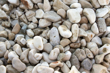 fragment of stony beach with smooth grey stone pebbles background