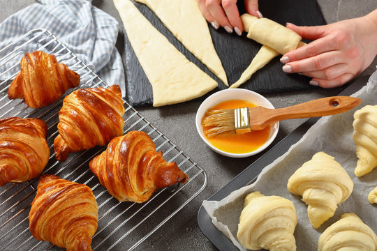 Woman is shaping dough to bake French croissants