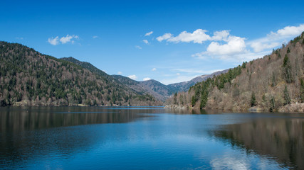 Fototapeta na wymiar panorama of lake of Kruth with clouds reflection in alsace - France