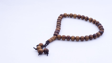 Closeup of  tasbih or rosary on a white background. Selective focus and copy space.