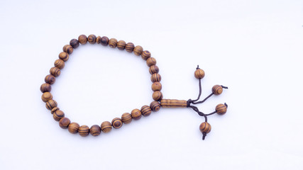 Closeup of  tasbih or rosary on a white background. Selective focus and copy space.