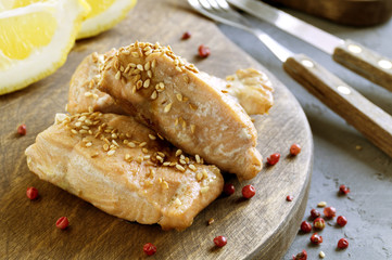 Cooked salmon fillet on a wooden Board.