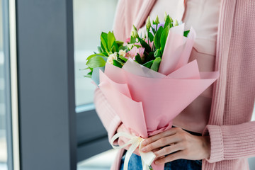 cropped shot of woman with bouquet of flowers in hands, mothers day concept