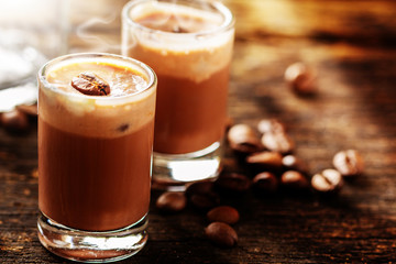 Cappuccino and coffee beans on wood