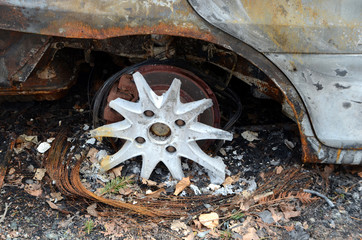 Fototapeta premium Closeup on what was the wheel of a totally burned out car.