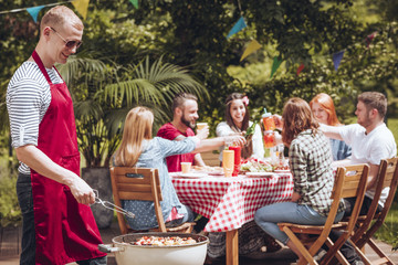 Happy man grilling during party