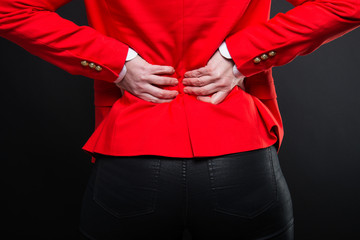 Back view of business woman holding back like hurting