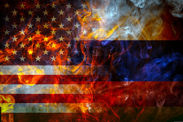 National flags of USA and Russia from a bright flame on a black background