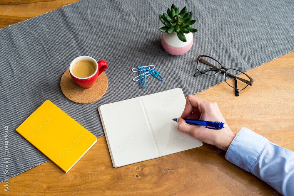 Wall mural empty notebook with copy space and hand as flat lay and template