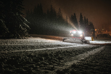 snow machine cleaning snow in dark