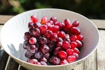 Grapes in a bowl, green background