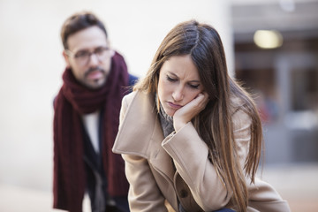 Portrait of young couple outdoor on street having relationship problems