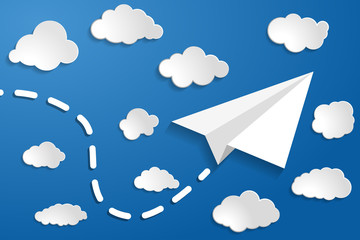 white paper aplane with clouds on a blue air background.  Blue sky travel background.