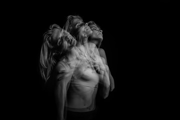 Emotional creative phantom portrait of young blonde woman. Black and white photo. triple exposure.