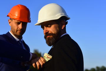 Bribery, business and corruption concept. Managers wear smart suits, ties