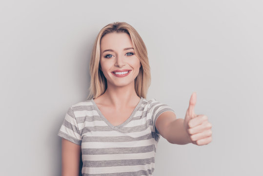 People person feedback concept. Close up portrait of excited cheerful joyful beautiful with modern trendy stylish hair hairdo giving you thumb-up wearing grey t-shirt isolated on gray background