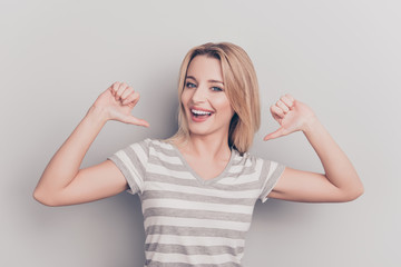 It is me! Portrait of smiling cheerful nice modern cute positive woman in casual outfit pointing thumb fingers at her body isolated on grey background, proud of herself, having ego - obrazy, fototapety, plakaty