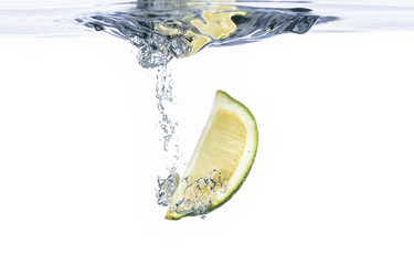 Fresh lime fruit water splash with bubbles