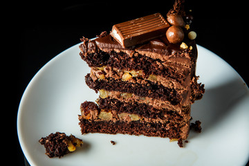 closeup piece of chocolate cake served on on white plate