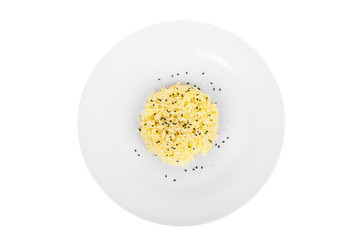 Long grain rice with white and black sesame cooked portion of side dish on a plate on a white isolated background view from above. Appetizing dish for the menu restaurant, bar, cafe