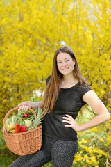 Naklejka na ściany i meble Beautiful attractive young woman holding healthy detox vegetable. Healthy lifestyle concept.